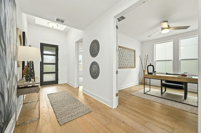 entrance foyer with ceiling fan and light wood-type flooring