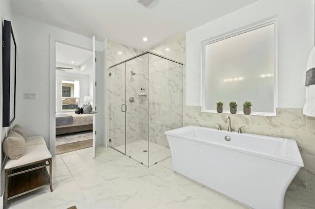 bathroom featuring separate shower and tub