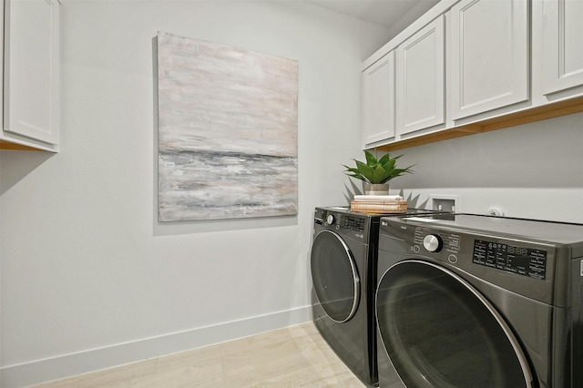 laundry room with cabinets and washer and dryer