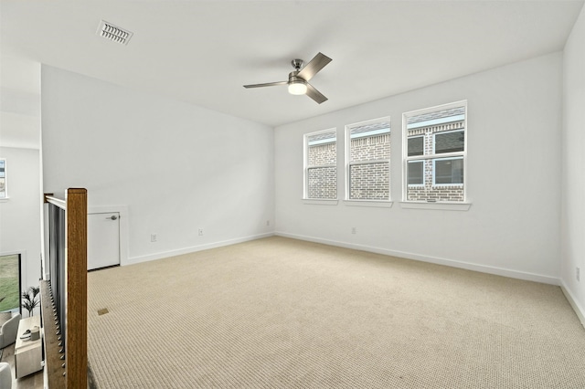 unfurnished room with ceiling fan and light carpet