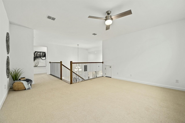 unfurnished room featuring light colored carpet and ceiling fan