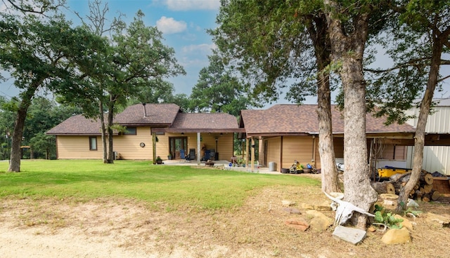 back of property featuring a yard and a patio area