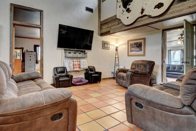 tiled living room with ceiling fan