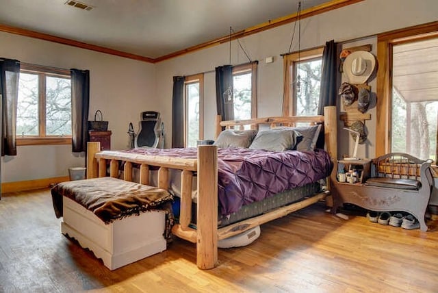 bedroom featuring wood-type flooring and ornamental molding