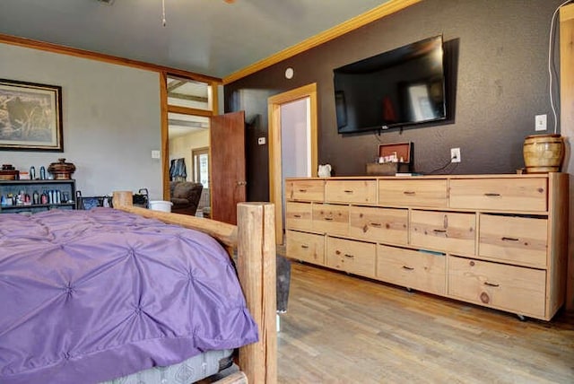 bedroom with crown molding and hardwood / wood-style flooring