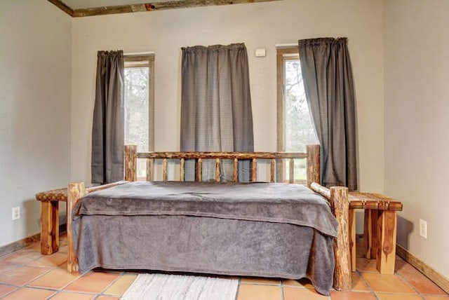 tiled bedroom featuring ornamental molding