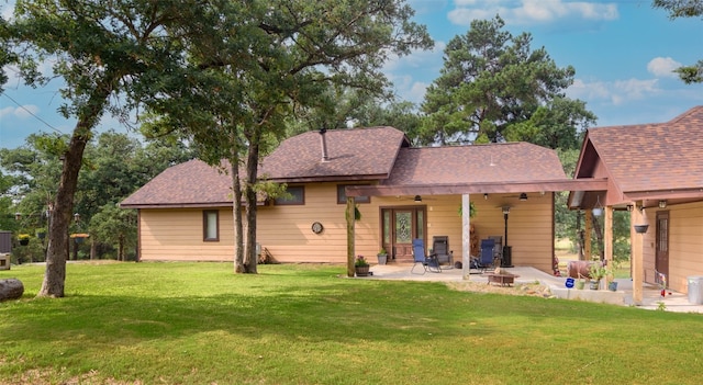 rear view of house featuring a yard, ceiling fan, and a patio