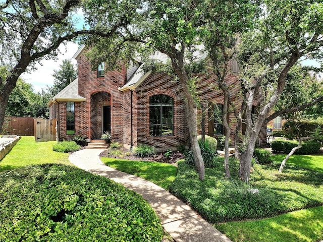 english style home with a front yard