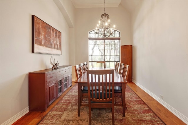 dining area with a chandelier and dark hardwood / wood-style floors