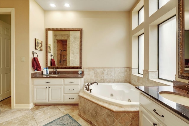 bathroom featuring tile patterned flooring, vanity, and separate shower and tub