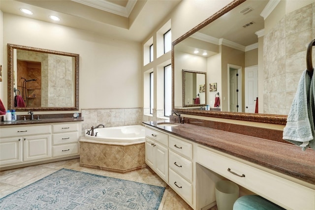 bathroom with tile patterned floors, tiled bath, crown molding, and vanity