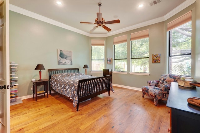 bedroom featuring light hardwood / wood-style flooring, ceiling fan, and crown molding