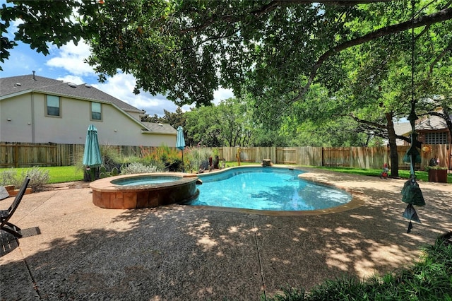 view of swimming pool featuring a patio area and an in ground hot tub