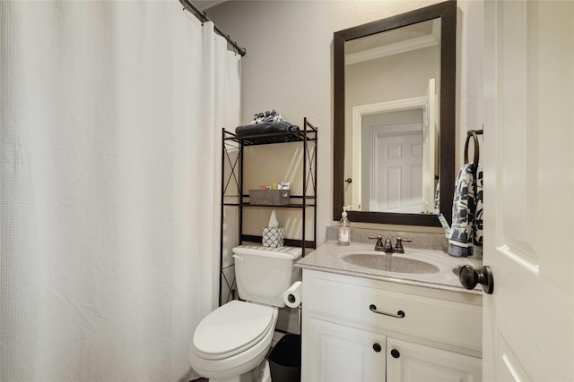 bathroom with vanity, toilet, and crown molding