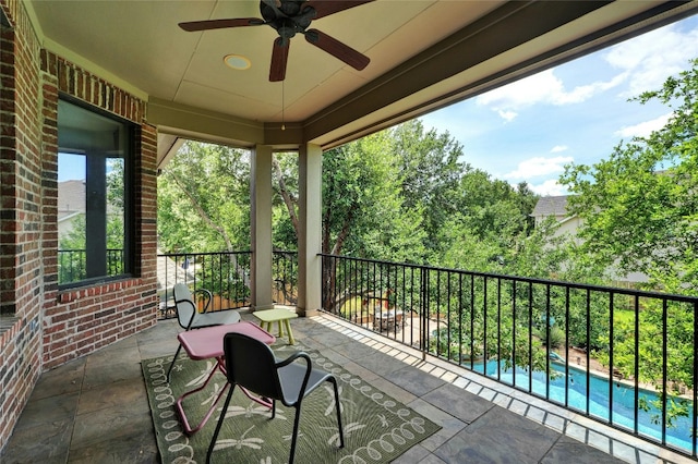 view of patio with a fenced in pool and ceiling fan