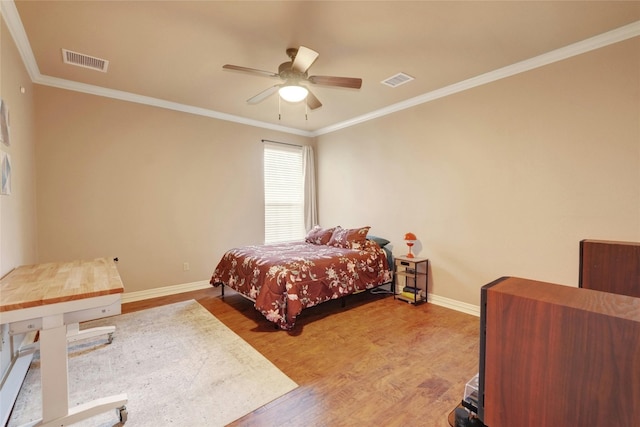 bedroom featuring hardwood / wood-style flooring, ceiling fan, and crown molding