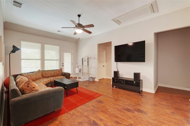 living room with ceiling fan, wood-type flooring, and crown molding