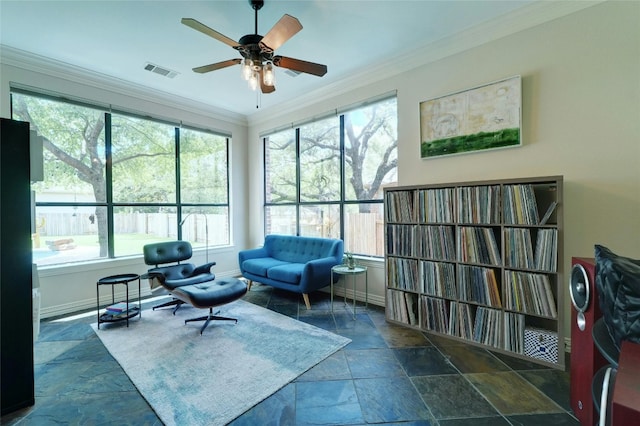 sitting room featuring ceiling fan and crown molding