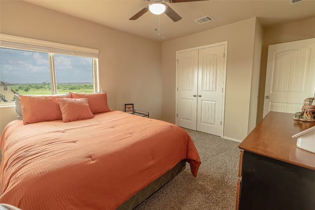 bedroom with a closet, ceiling fan, and carpet floors