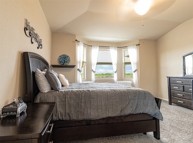 carpeted bedroom featuring ceiling fan and vaulted ceiling