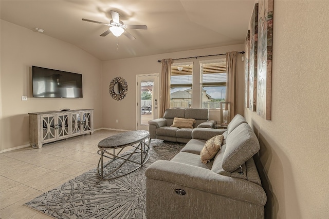 tiled living room featuring ceiling fan and lofted ceiling