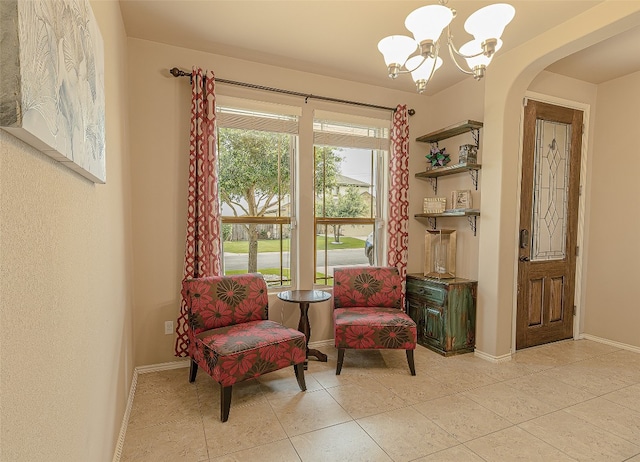 living area with an inviting chandelier and light tile flooring