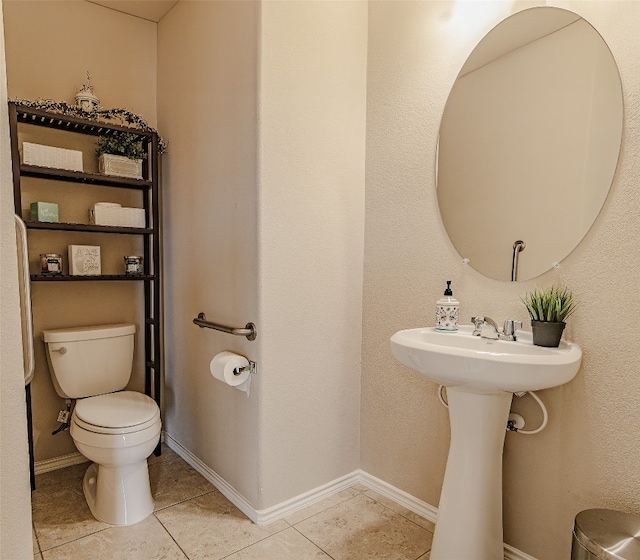 bathroom featuring tile flooring and toilet