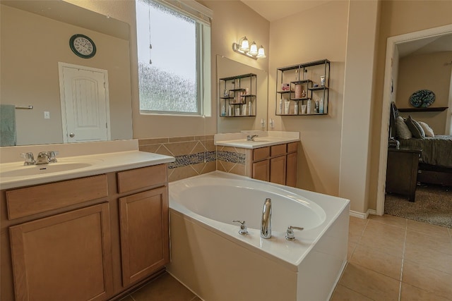 bathroom featuring tile floors, a bathtub, vanity with extensive cabinet space, and dual sinks