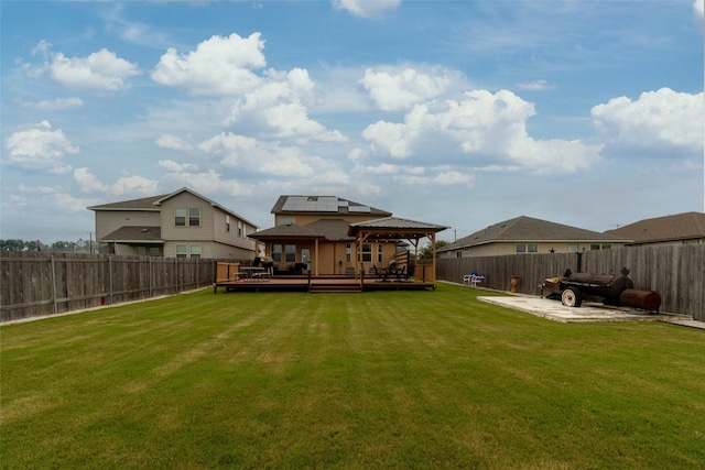 rear view of house featuring a patio, a gazebo, a deck, and a yard