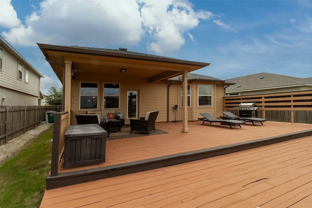 wooden deck with an outdoor hangout area and a grill