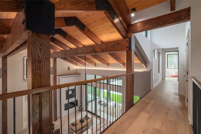 hallway featuring wooden ceiling, lofted ceiling with beams, and wood-type flooring