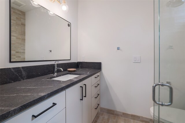 bathroom featuring tile floors, toilet, and vanity