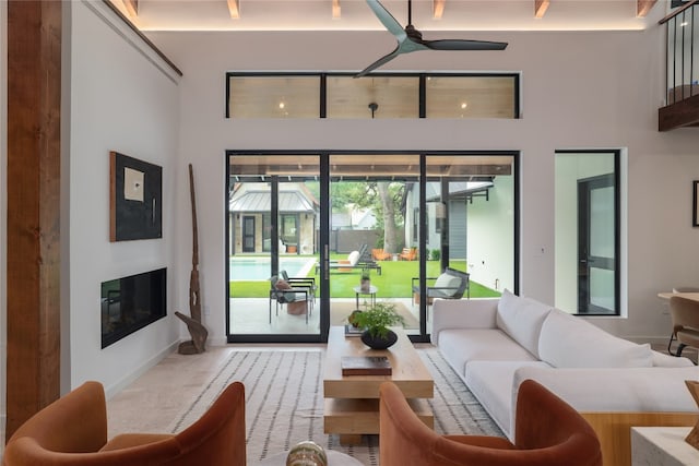 living room featuring a towering ceiling and carpet floors