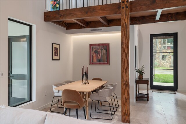 tiled dining room with beam ceiling