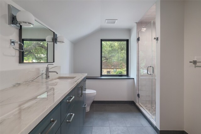 bathroom with a shower with shower door, tile floors, lofted ceiling, toilet, and vanity