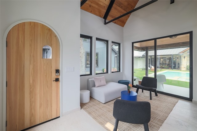 living room with wood ceiling, high vaulted ceiling, and light tile flooring