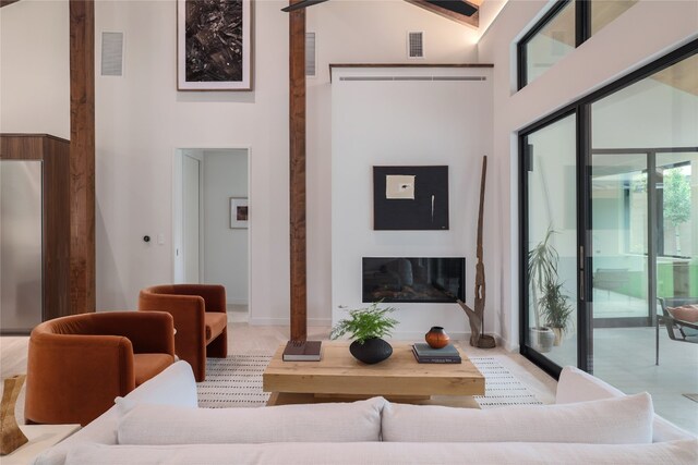 living room featuring a towering ceiling