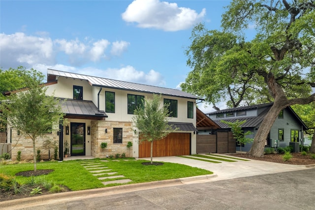 view of front of property featuring a front yard and central AC unit