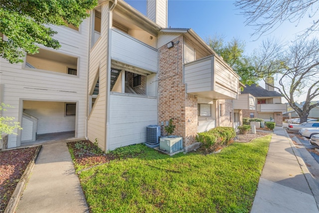 view of property exterior with a garage, central AC unit, and a balcony