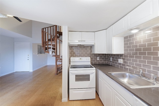 kitchen featuring light hardwood / wood-style floors, electric stove, backsplash, and white cabinetry