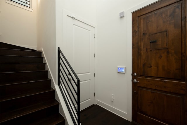 staircase with dark hardwood / wood-style floors