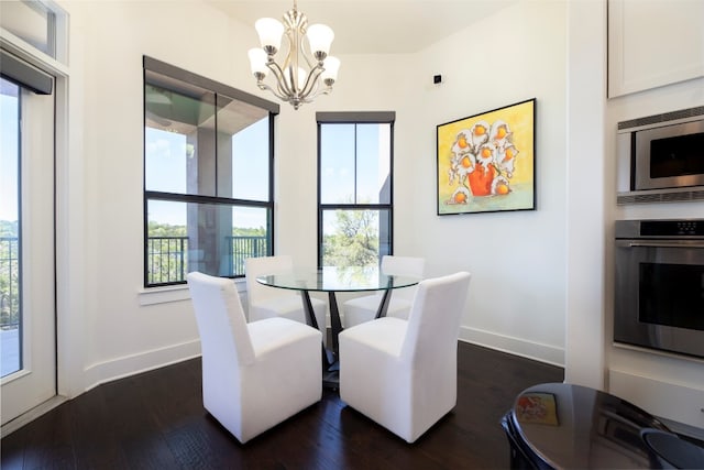 dining space featuring a notable chandelier and dark hardwood / wood-style floors