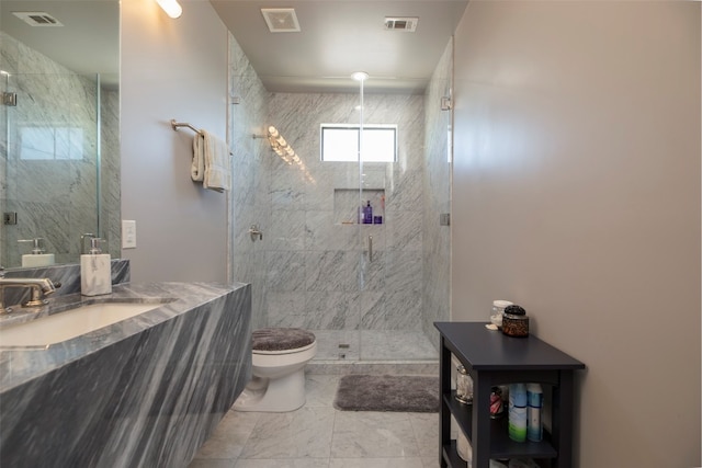 bathroom featuring a shower with shower door, tile flooring, vanity, and toilet