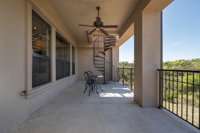 view of patio featuring a balcony and ceiling fan