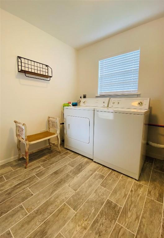 laundry room featuring washer and dryer and hardwood / wood-style flooring