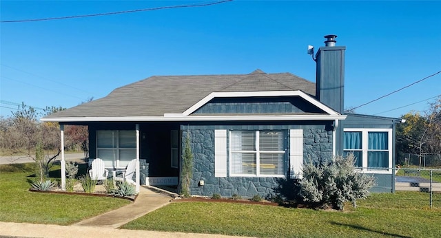 view of front of house with covered porch and a front lawn