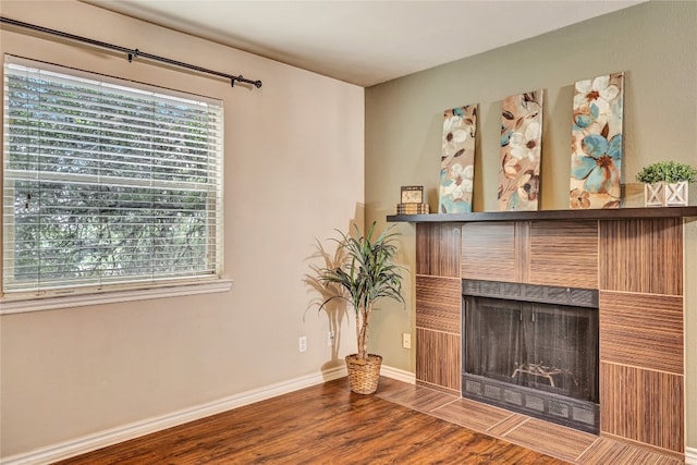 unfurnished living room featuring a fireplace and hardwood / wood-style flooring