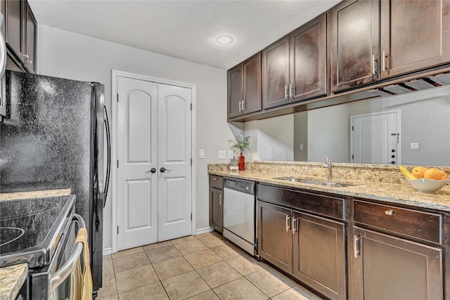 kitchen with sink, stainless steel appliances, light stone counters, dark brown cabinets, and light tile patterned floors