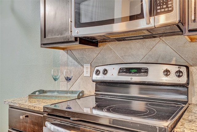 kitchen featuring tasteful backsplash and electric range