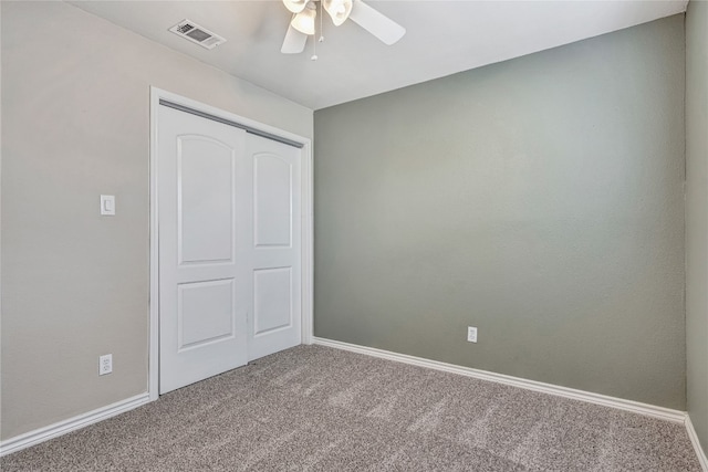 unfurnished bedroom with ceiling fan, carpet floors, and a closet